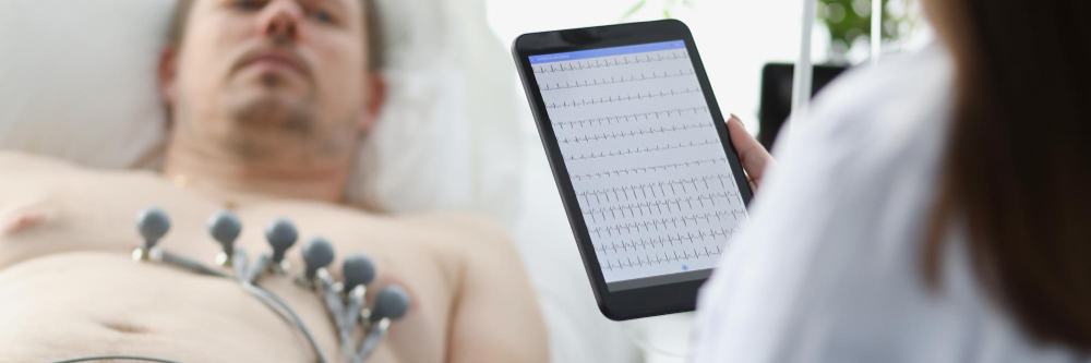 Doctor reviewing a heart rhythm recording on a tablet